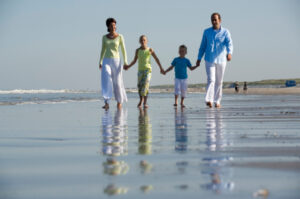 happy family walking along the beach