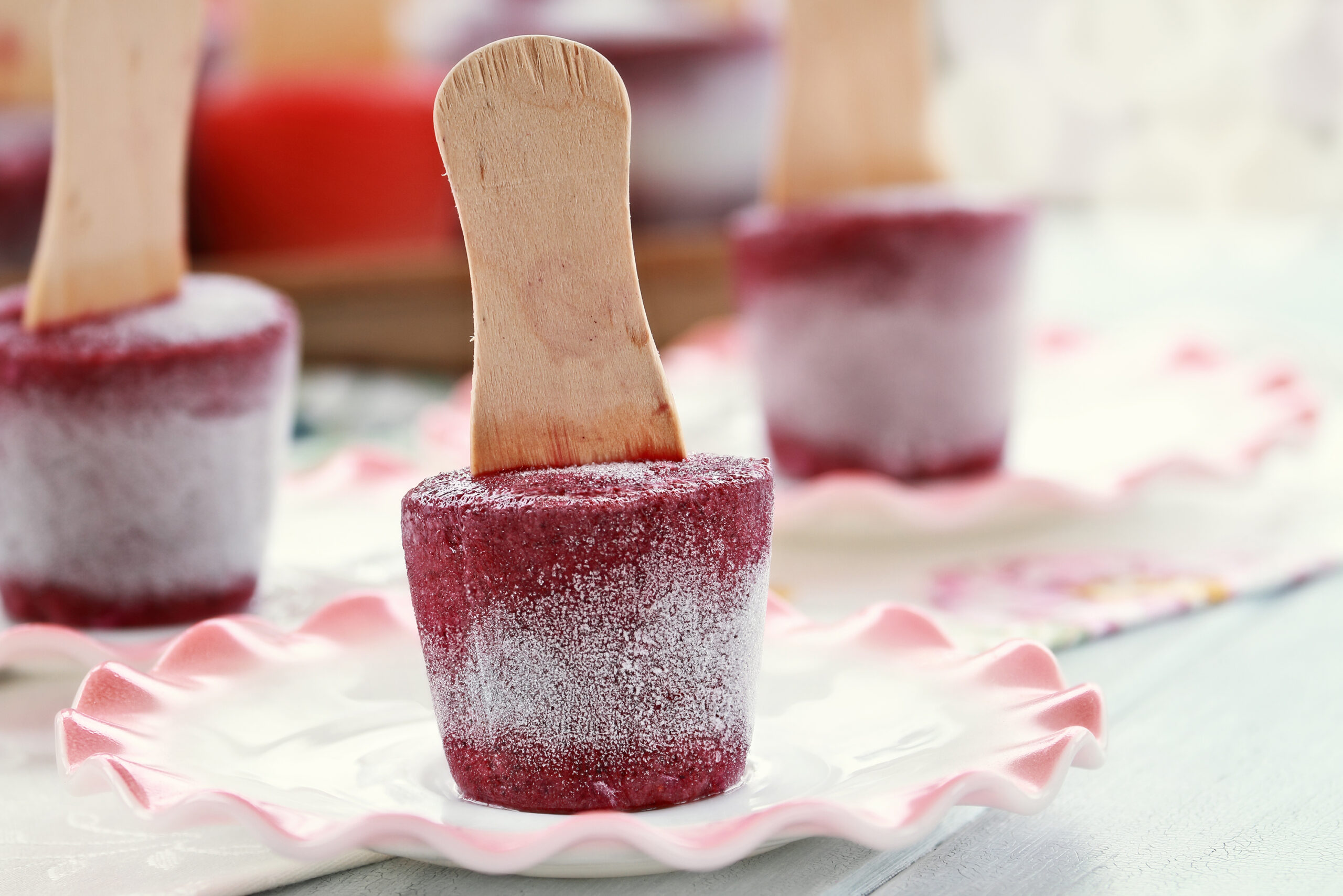 Blueberry popsicles made from blueberries and yogurt. Extreme shallow depth of field with selective focus on  popsicle in front.