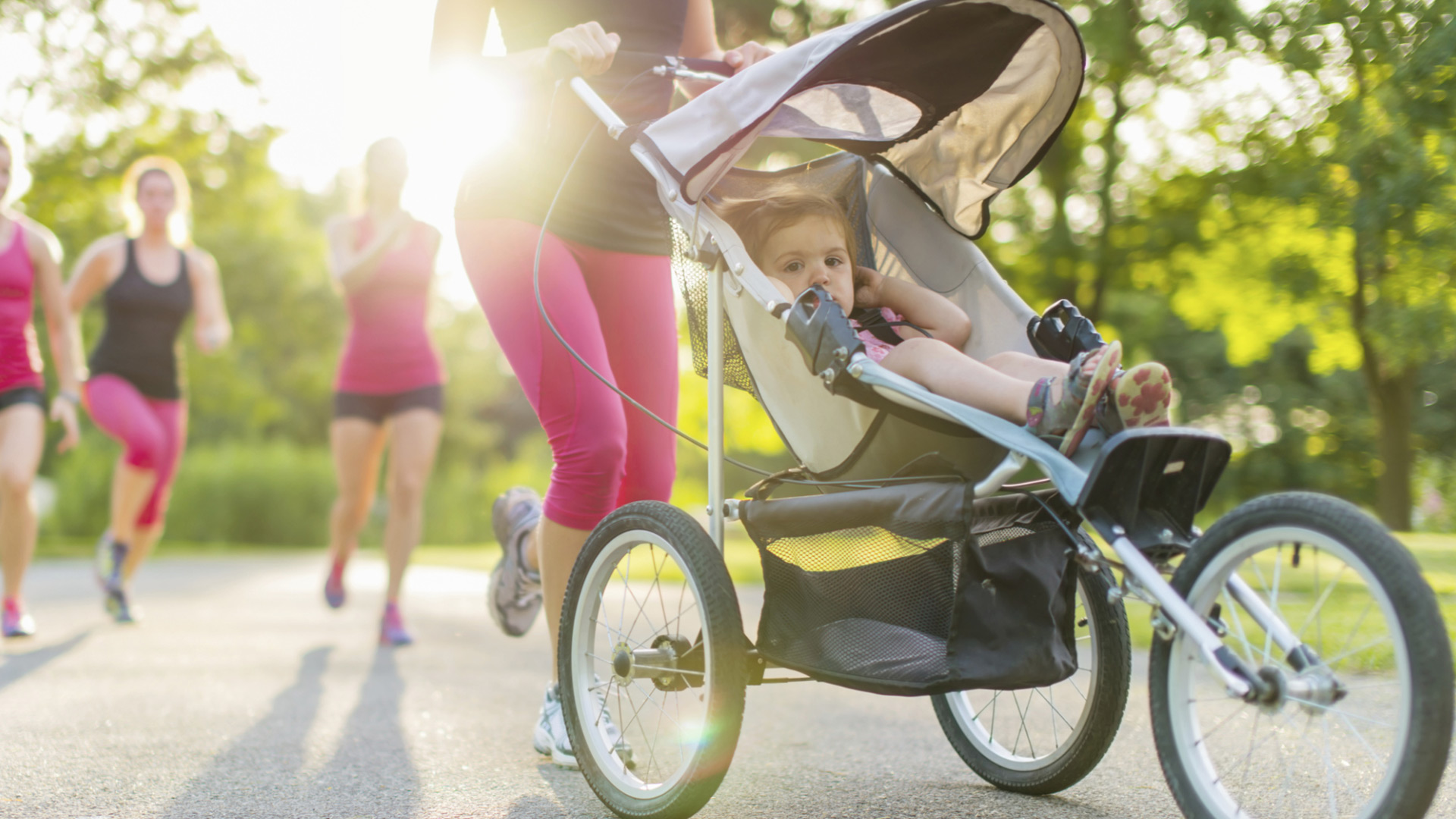 Woman jogging with stroller getting daily exercise